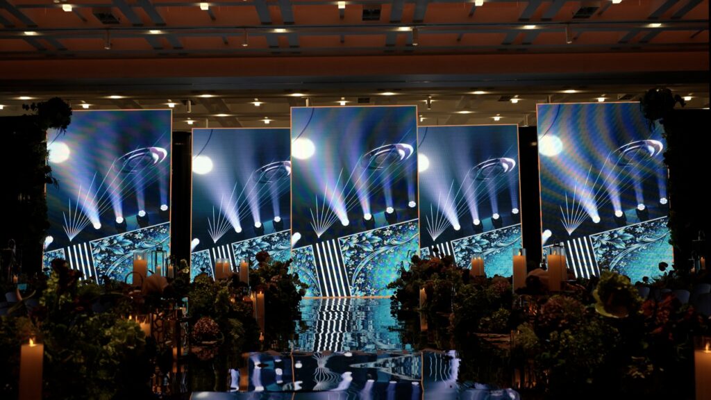 Catwalk fashion show with a central runway, LED screens and stage lighting